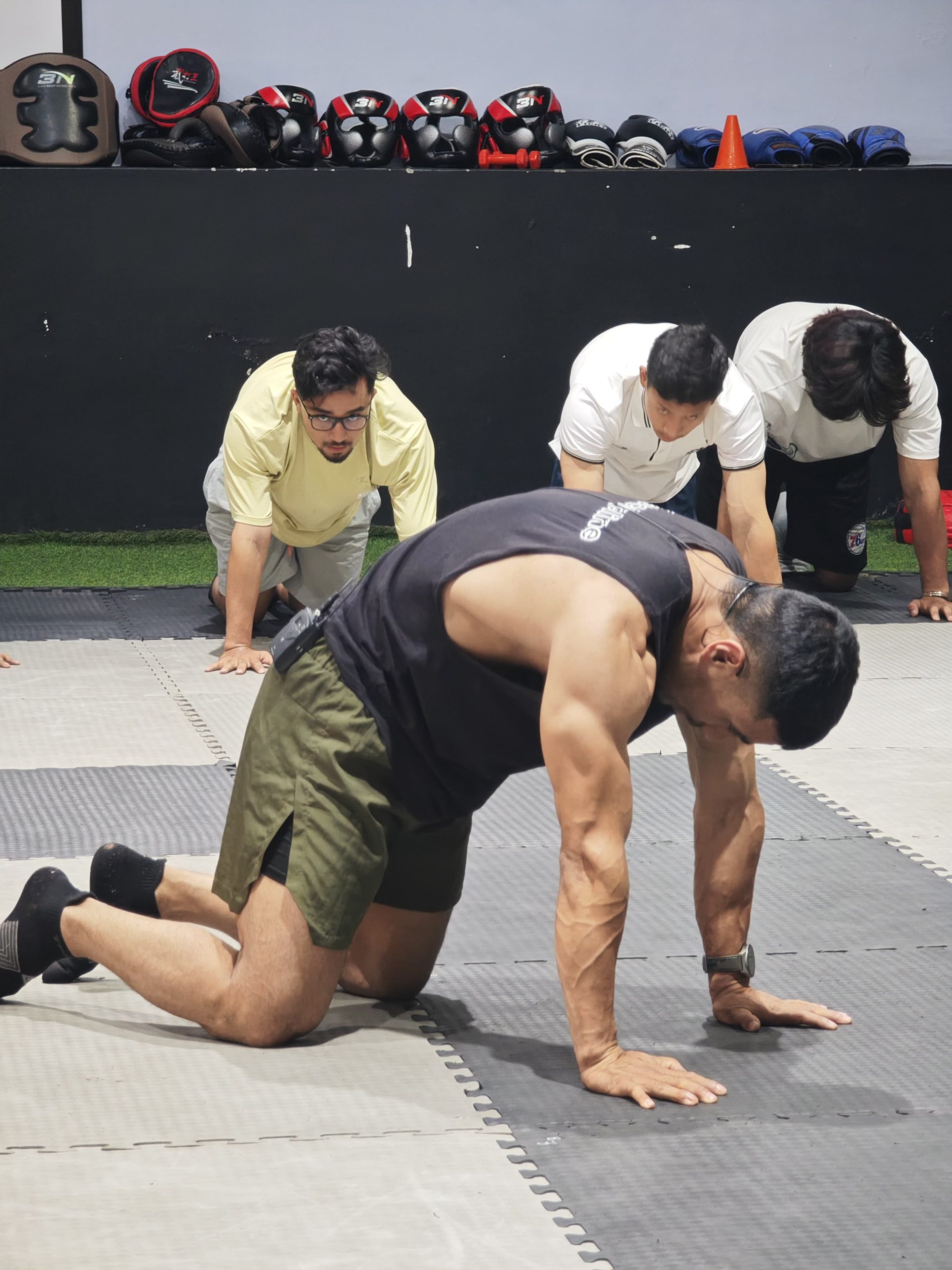 NYFA Nepal mobility training — students practicing Cow-Cat exercise for spinal flexibility and core stability.