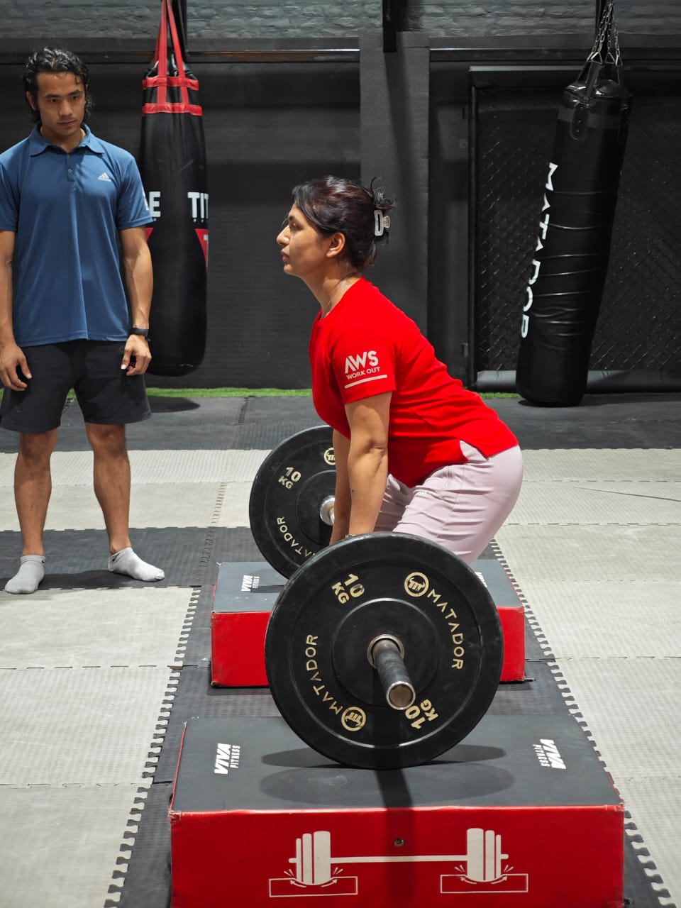NYFA Nepal strength training fundamentals — students learning proper deadlift technique with Olympic lifting coaching.